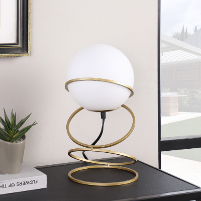 LUMÈRA gold table lamp styled with books and home decor accessories