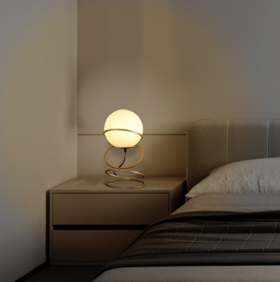 LUMÈRA The Glow modern gold spiral lamp on bedside table with warm ambient light